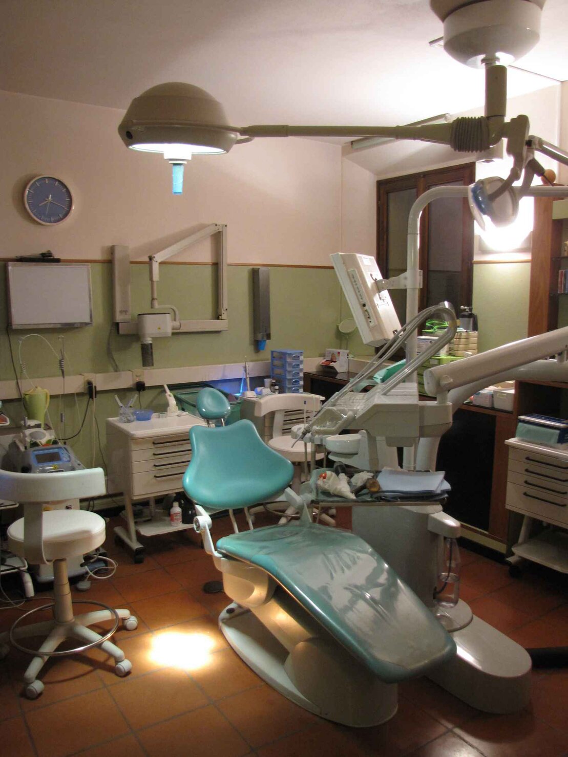 Dentista con camice che sorride in uno studio professionale